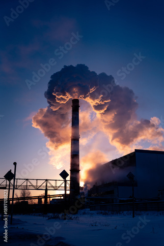 Winter sunrise over a coal-fired power plant, highlighting urban air pollution and environmental impact. Russia
