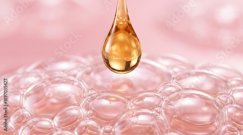 A golden droplet poised above a textured pink surface of delicate bubbles