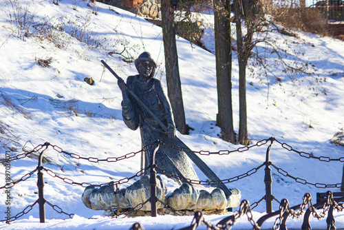 Brass statue of traditional Polish raftsman. winter. Grudziadz