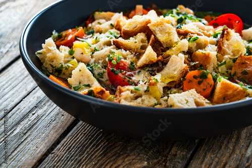 Konstfotografi Ribollita - tuscan vegetable soup with white bean and stale bread on wooden tabl