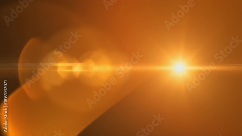 Dynamic abstract optical lens flare with bright warm light ray on dark background, ideal for digital design and cinematic video overlays