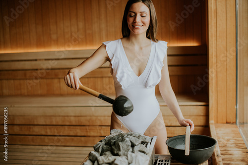 Woman enjoying sauna time w...