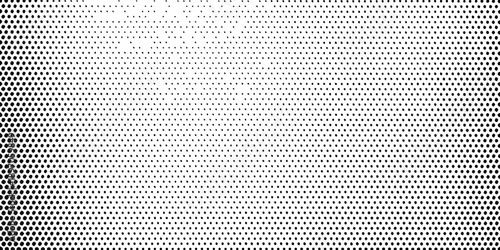 A dense uniform pattern of small black dots on a white background