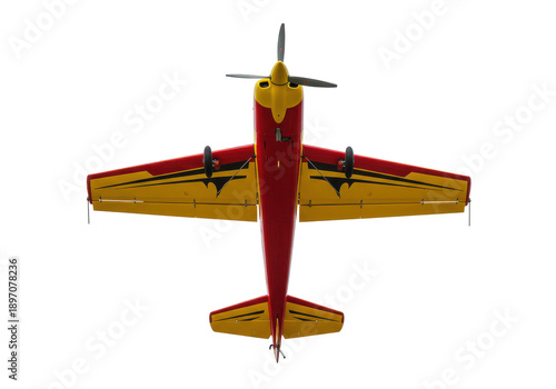 Top-down view of a red and yellow model airplane with a three-blade propeller isolated on white background