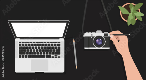 Flat lay of laptop, camera, pencil, and potted plant on a desk