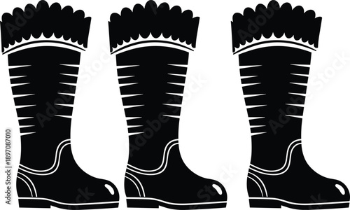 Winter rubber boot silhouettes set with fur trim, waterproof footwear icons in black vector style for cold weather, farming, outdoor, and seasonal design projects