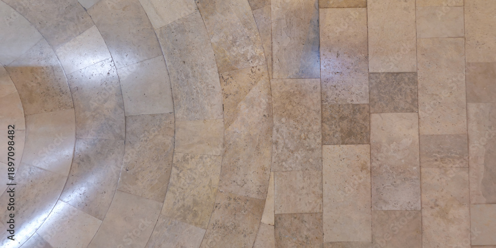 Obraz premium top view of surface of pedestrian path with paving slabs with the border of light and shadow