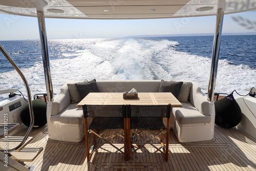 A boat with a table and chairs on the deck