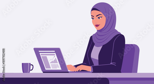 Confident young Arab Muslim businesswoman wearing a stylish hijab diligently working on laptop at a modern office desk