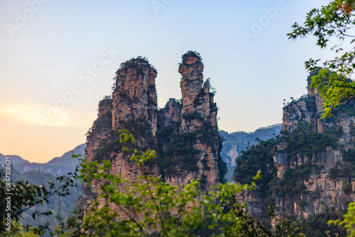Zhangjiajie national forest park. The mountains are covered in trees and the sky is blue