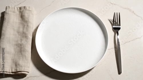 Minimalist Table Setting White Plate Linen Napkin and Silver Fork on Marble Surface