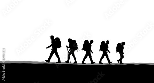 Silhouettes of hikers walking in a line on a path.