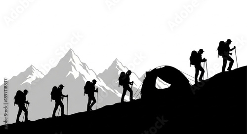 Silhouettes of hikers climbing a mountain trail with snow-capped peaks in the background.