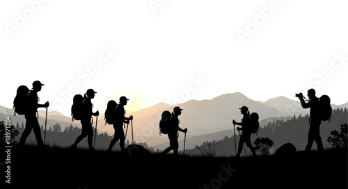 Silhouette of hikers walking on a mountain trail at sunset.