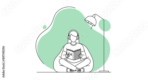 Person reading a book on the floor beside a green lamp in a relaxation, contemplative setting