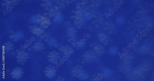 Blurred blue bokeh lights creating a serene and dreamy atmosphere, perfect for backgrounds and overlays. Slow motion.