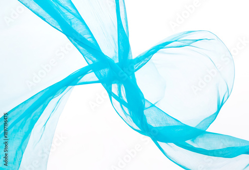 Transparent light blue fabric draped in waves
