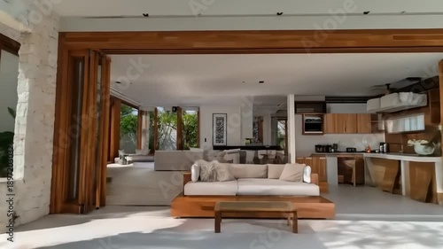 Modern villa with swimming pool and open spaces in bright sunlight