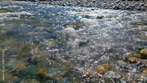 Wallpaper Mural Clear Mountain Stream Water Flows Over Colorful Rocks Sunlight Sparkles on Rippling Surface Torontodigital.ca