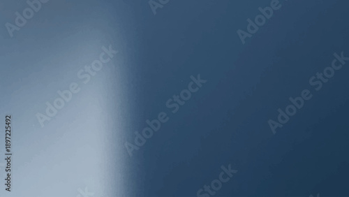 A smooth gradient of light blue abstract background with a brushed metallic steel texture and silver gray aluminum plate design for a sleek dark backdrop