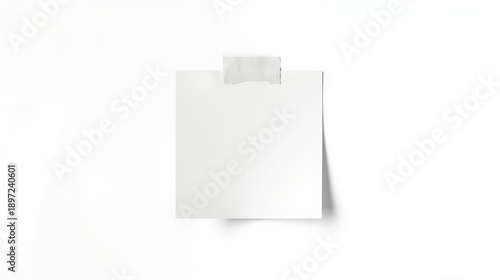 A minimalist studio photograph features a blank white square sticky note taped to a white background. The note is centered and slightly curled at the bottom, secured with a small strip of.
