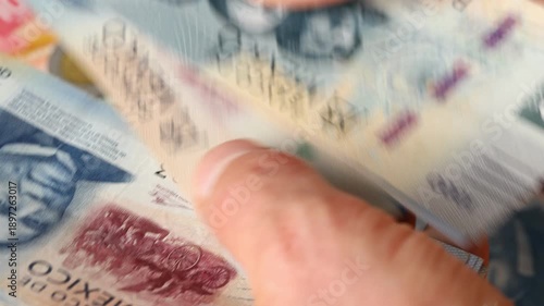 Mexico peso. A large amount of cash. A man is counting Mexican money in his hand. Financial concept. Business background. Close up