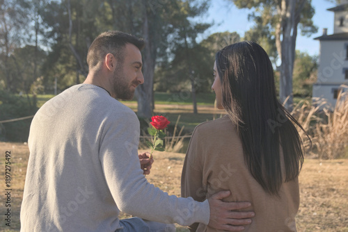 Couple in love sitting back to back in nature