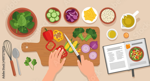 Top-down view of hands chopping fresh vegetables on a cutting board with various ingredients and a recipe book for healthy cooking.