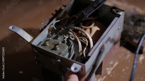 repair of a microcircuit with a soldering iron and a tweezers close-up