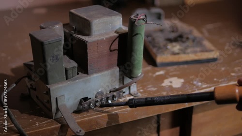 repairing contacts on an old radio amplifier using a soldering iron close-up