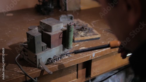 repairing contacts on an old radio amplifier using a soldering iron close-up