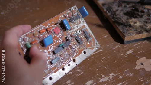 de-soldering the contacts on the radio amplifier using a soldering iron