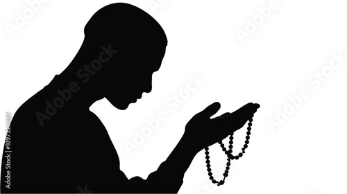 Silhouette of a person praying with rosary beads.