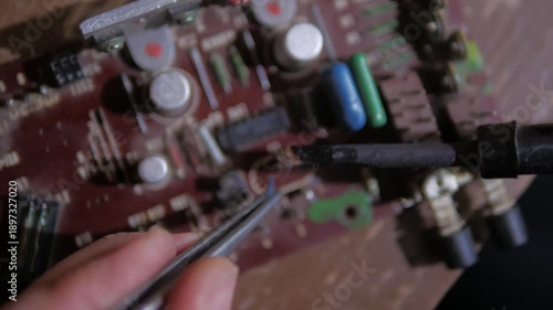 repairing a microphone amplifier using a soldering iron