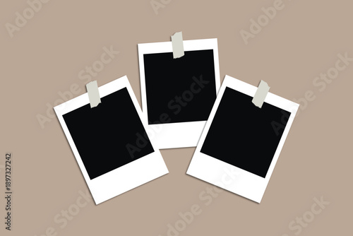 Three blank polaroid photos on a beige background with clothespins