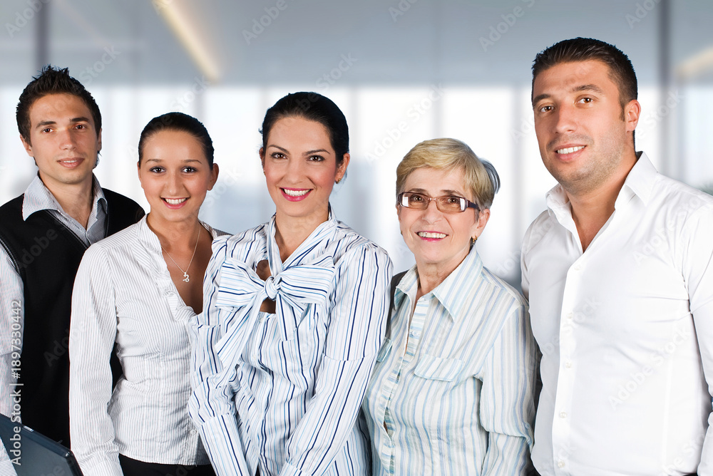 Fototapeta premium A group of people are smiling for a photo, with one woman wearing a tie