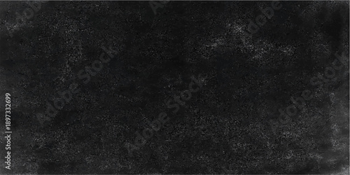 A dark and aged black chalkboard background with a rough grunge texture features a vintage blank surface and a gray stone pattern framed by a dirty old wall