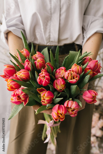 Woman holding vibrant pink tulips bouquet
