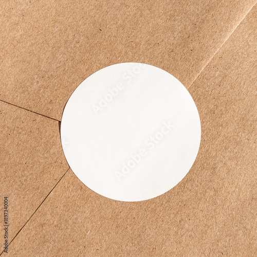 Brown kraft paper envelope with blank circular sticker for mailing and packaging