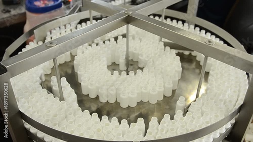 small bottles are moving on conveyor