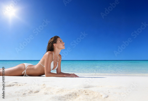 Woman on the beach in white bikini