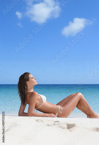 Woman on the beach in white bikini
