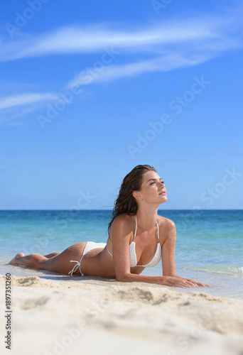 Woman on the beach in white bikini
