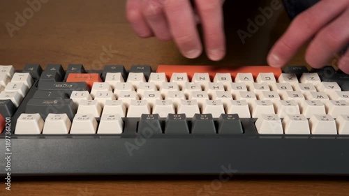Male hands typing on a computer keyboard