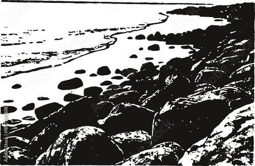 Rocky shoreline with scattered large stones along the coast and ocean waves at the horizon