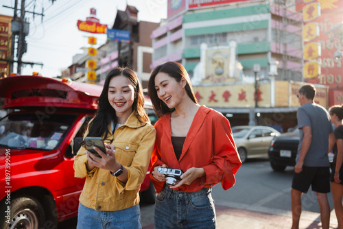 Photography Two young Asian women exploring city street