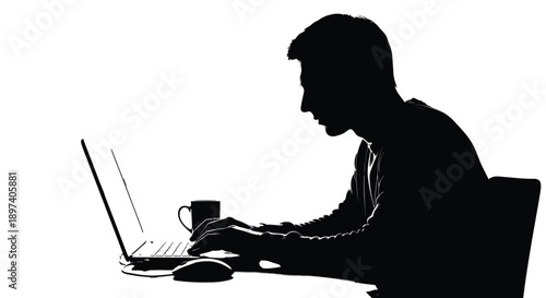 Silhouette of a focused man working intently on a modern laptop computer with a mug nearby.