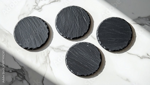 Round Black Slate Coasters on Marble Surface