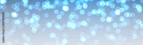 Magical blue bokeh with glittering confetti and glowing particles. Luxurious festive background with shimmering stardust and bright illumination.