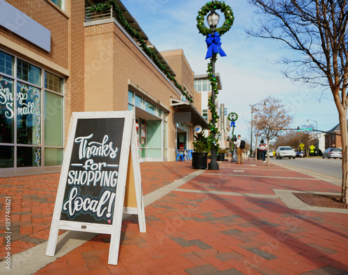 Thanks For Shopping Local sign in downtown Holly Springs , North Carolina, decorated for the Christmas season